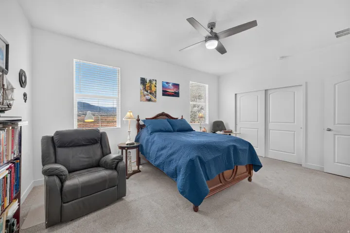 Spacious room featuring neutral carpeting and white walls