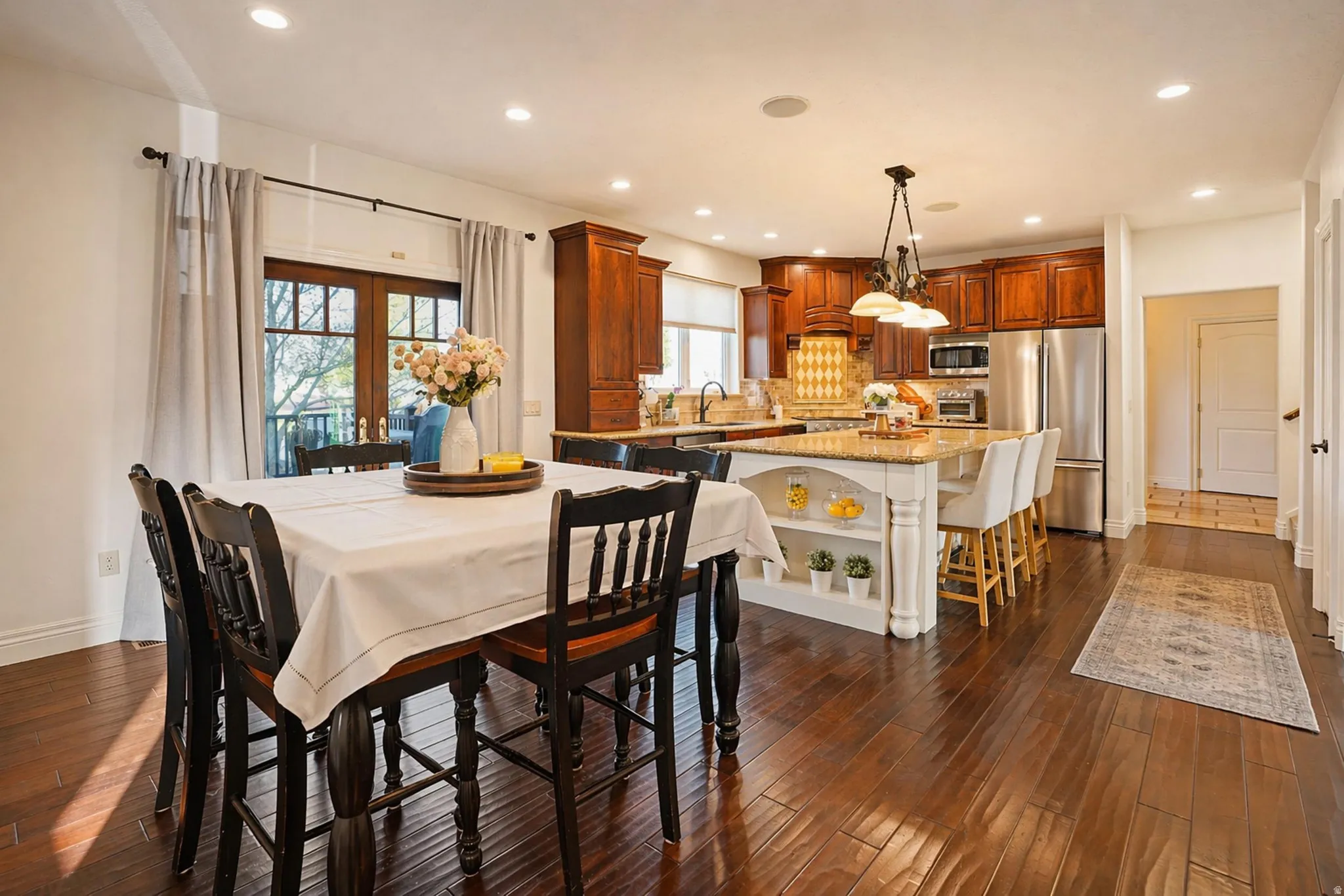 Dining space featuring recessed lighting, dark wood finished floors, and french doors