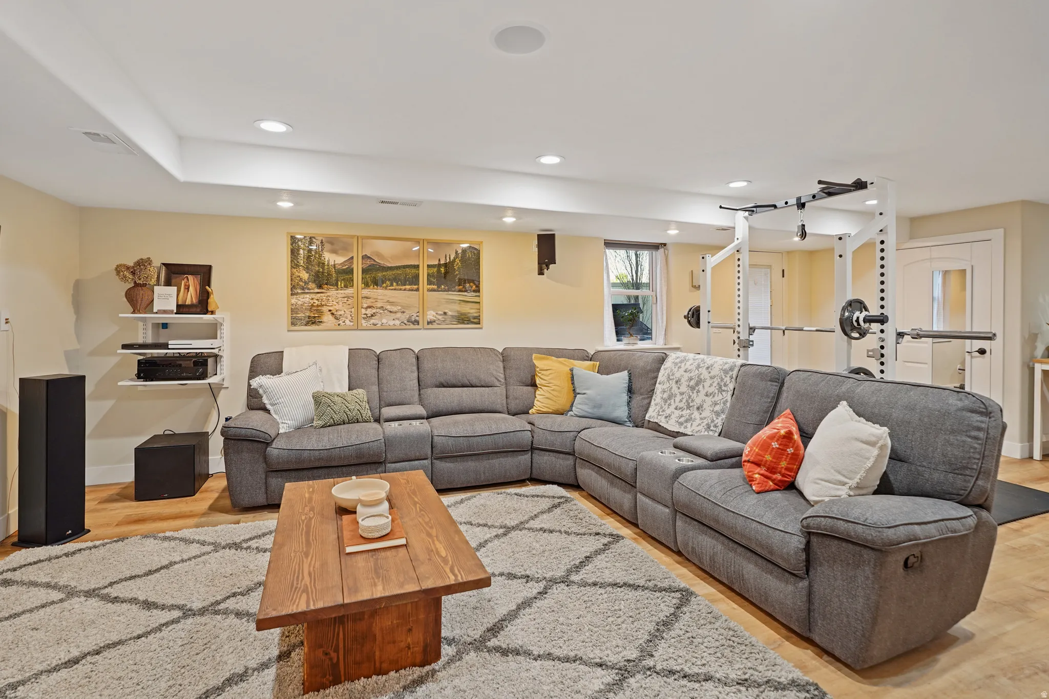 Living room with light wood-style flooring and recessed lighting