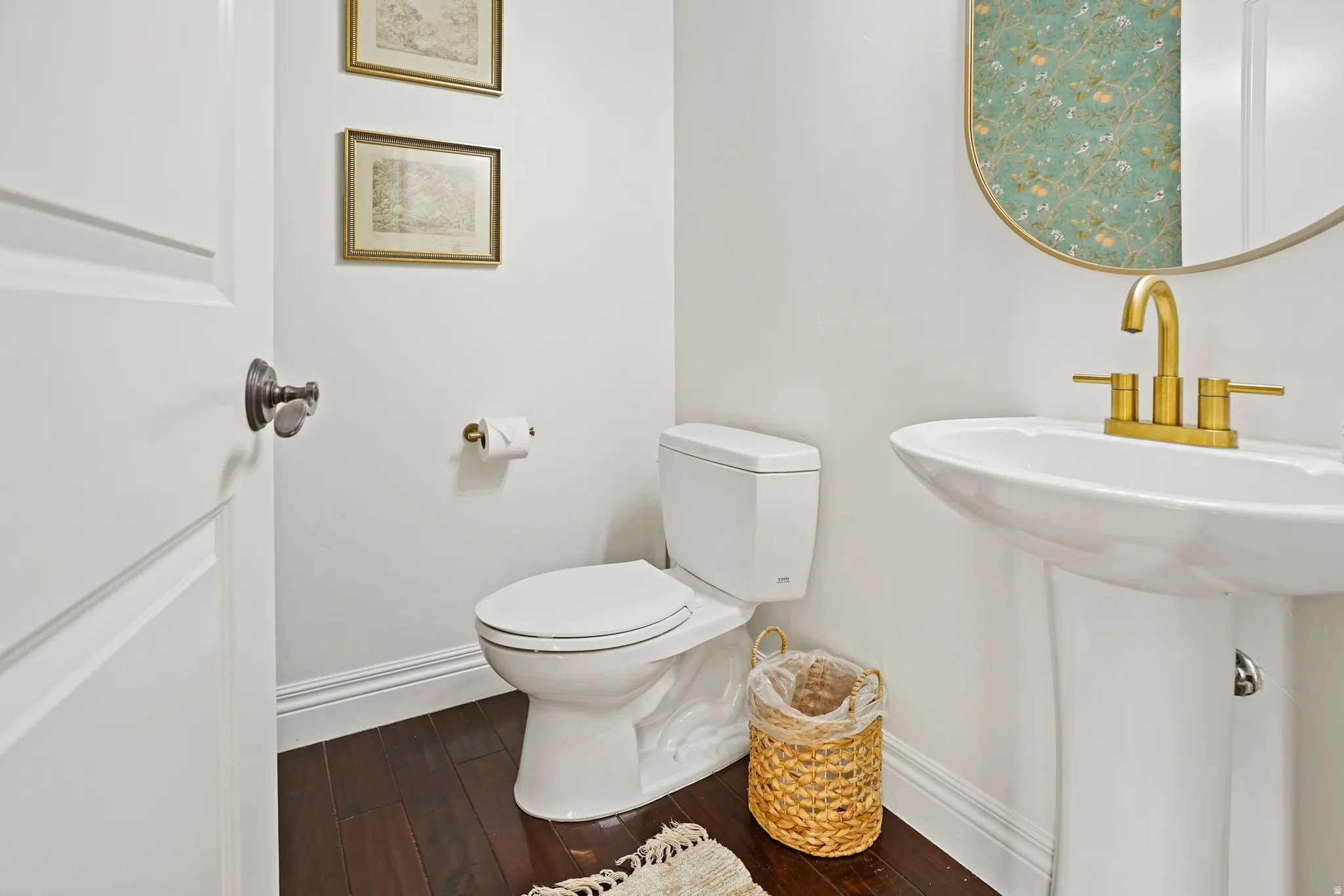 Half bath with baseboards and dark wood finished floors