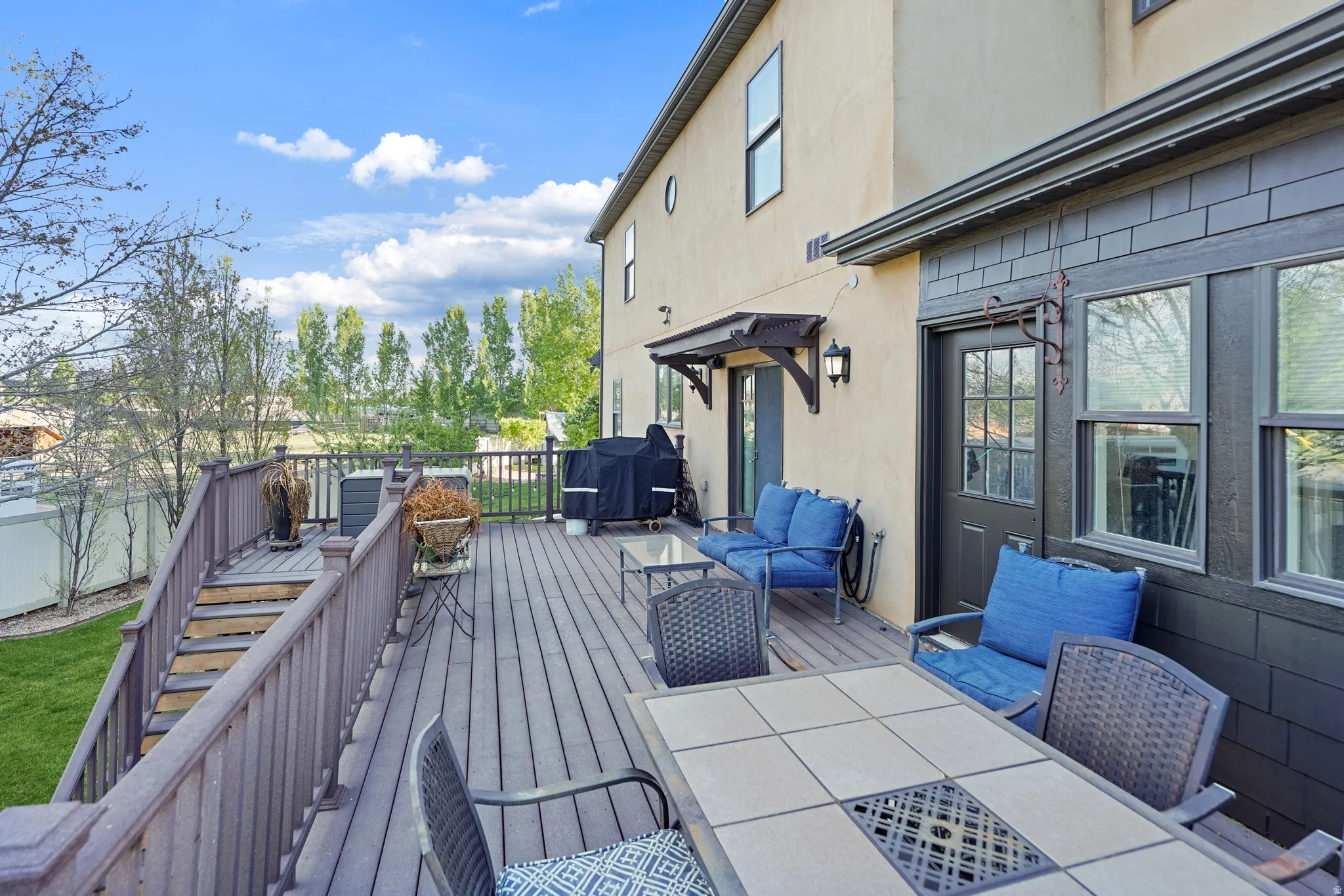 Wooden terrace with outdoor lounge area and area for grilling