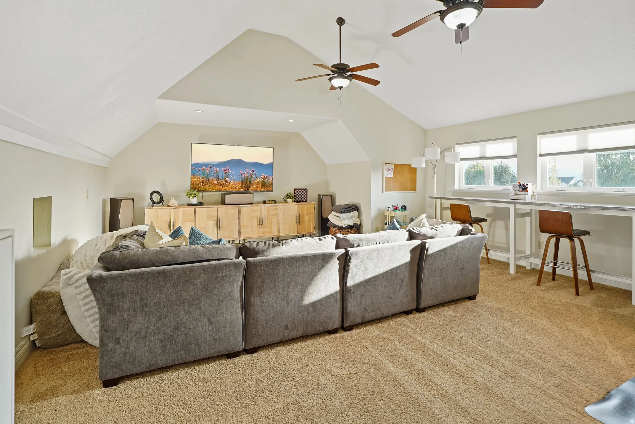 Living room featuring light carpet and ceiling fan