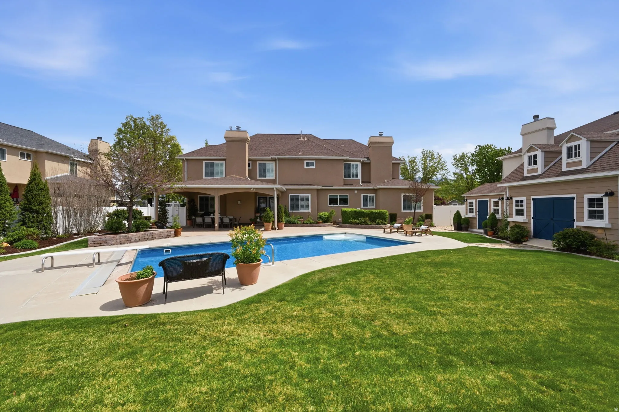 Rear view with swimming pool and custom sheds
