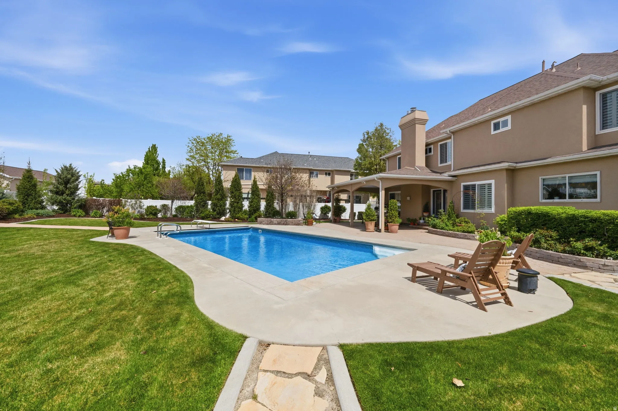 Additional view of swimming pool with patio surround and a diving board