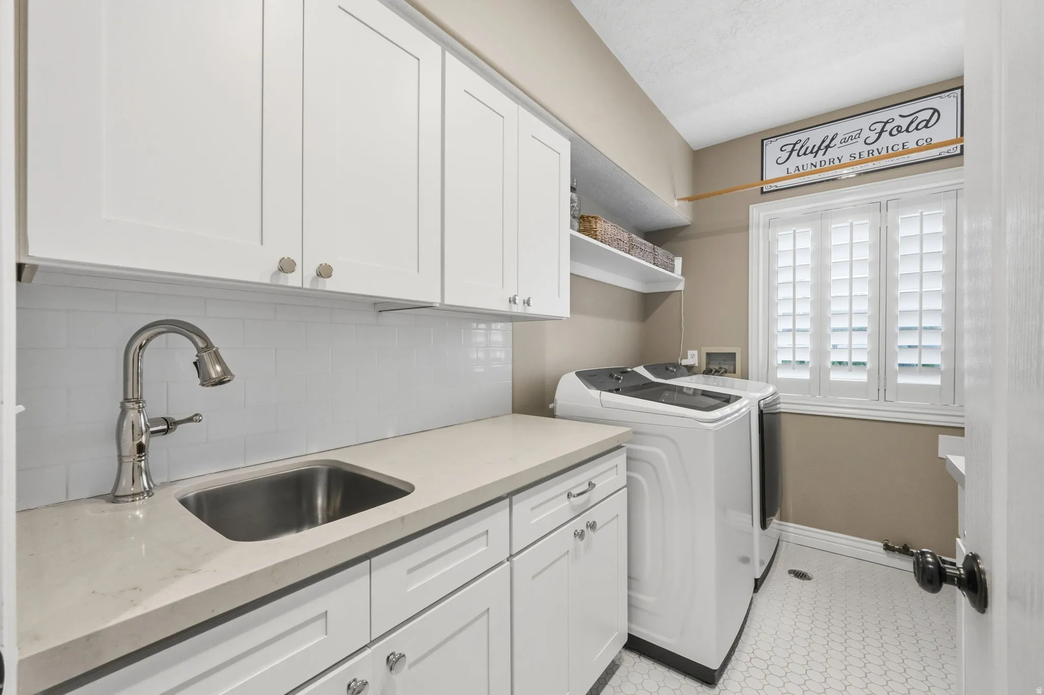 Remodeled laundry room with cabinets