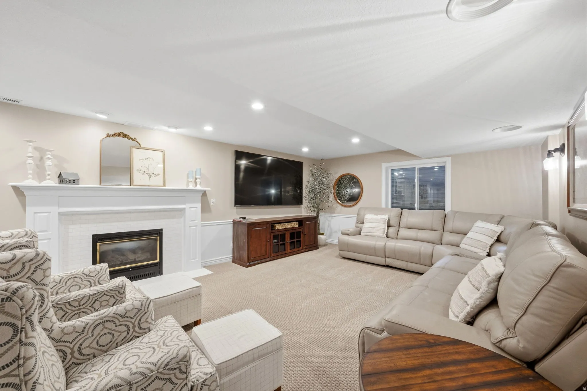 Basement family room with recessed lighting and a fireplace