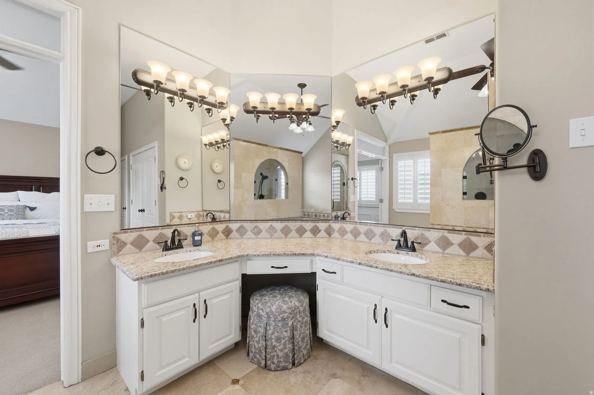 Ensuite bathroom featuring double vanity and high ceiling