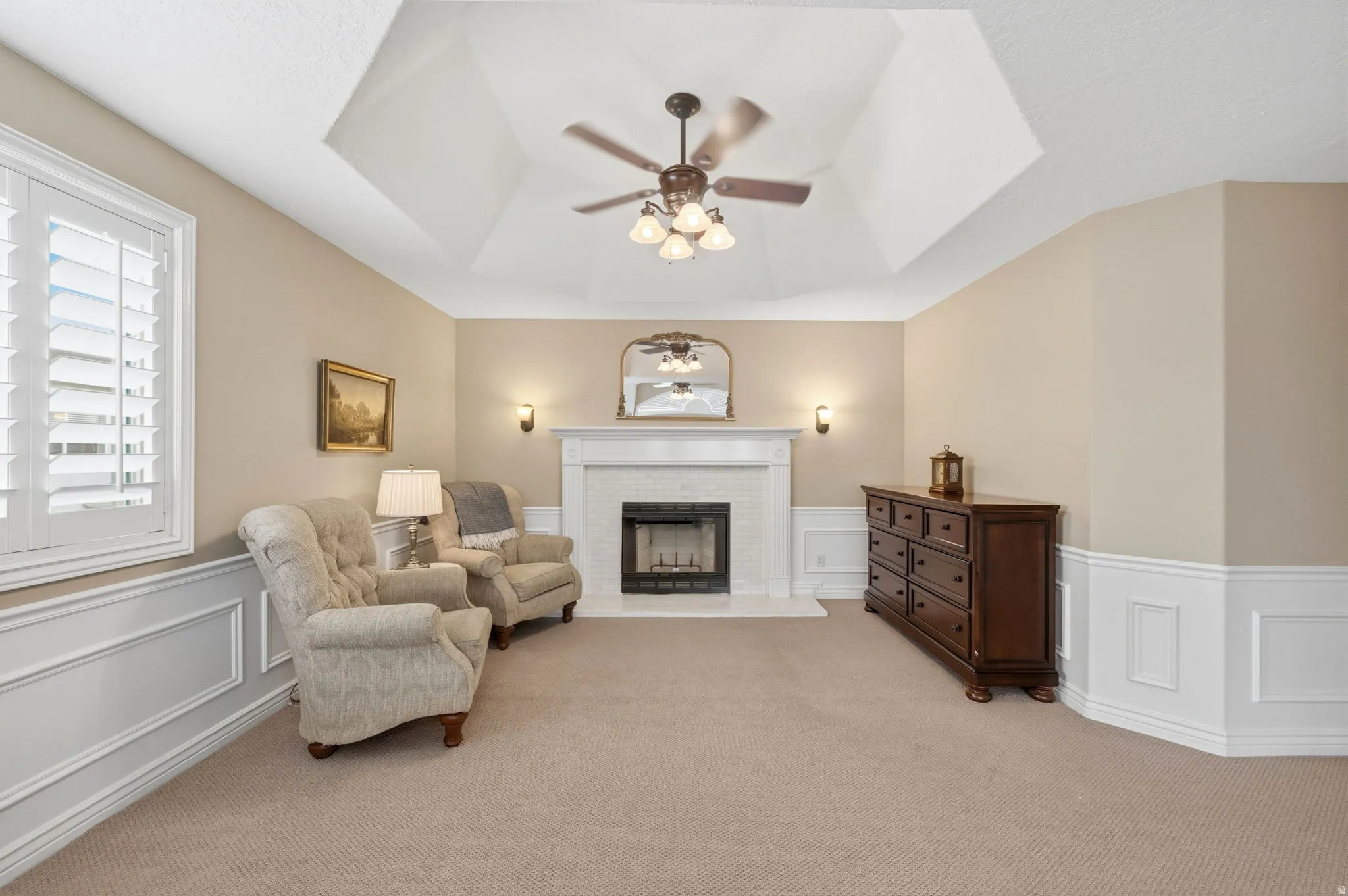 Sitting area with a fireplace in the primary bedroom