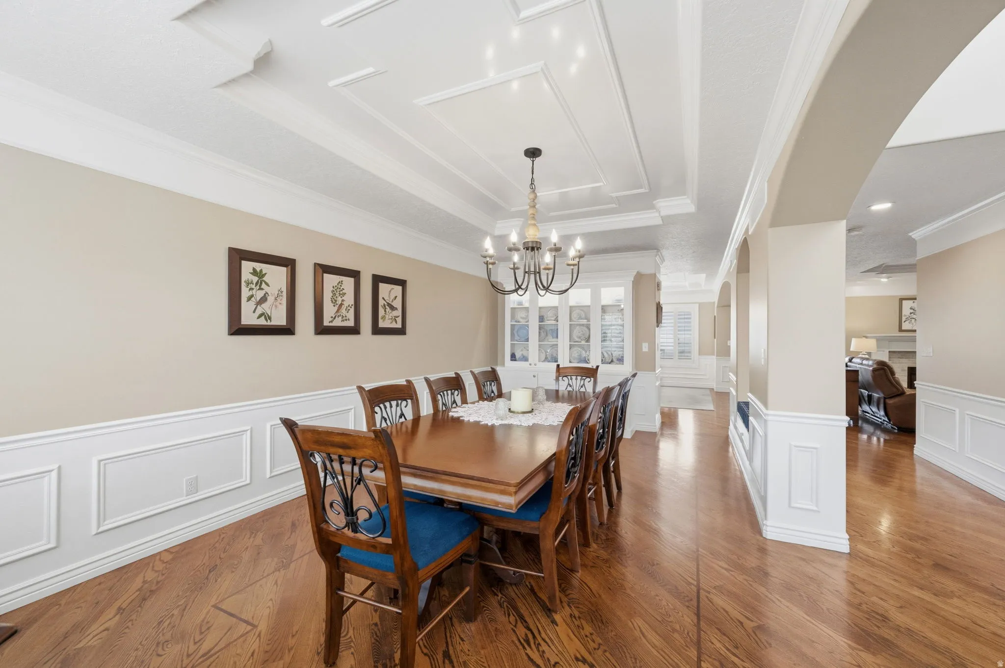 Formal Dining room with picture frame molding, crown moldling, hardwood flooring and built in china hutch.