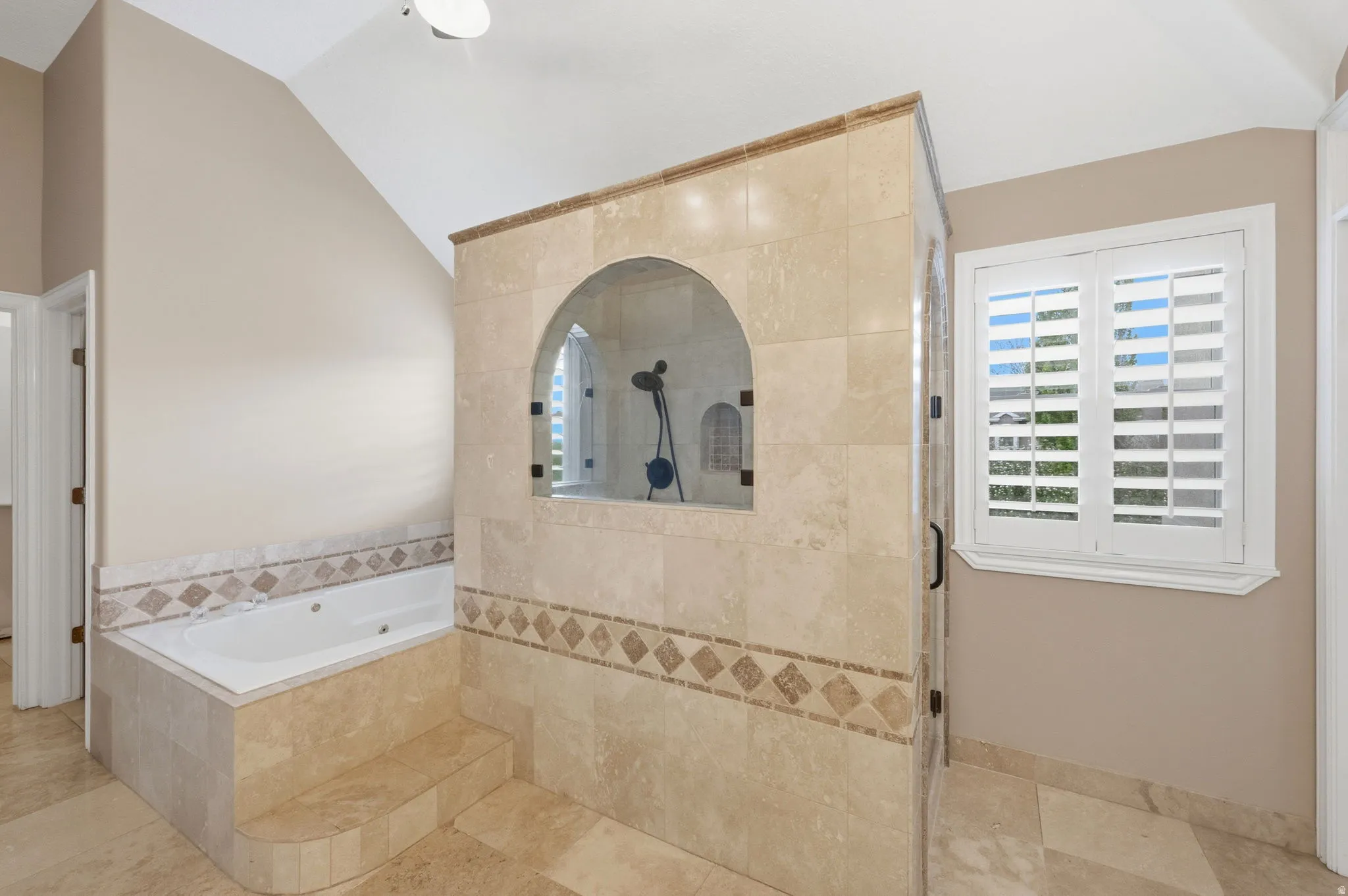 Ensuite bathroom featuring tiled shower, and separate bathtub