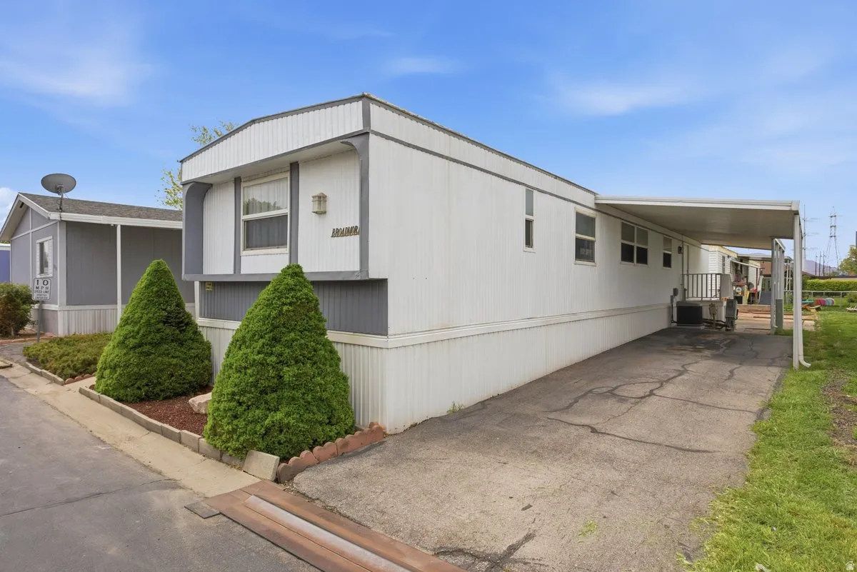 North Side with covered carport and uncovered parking space