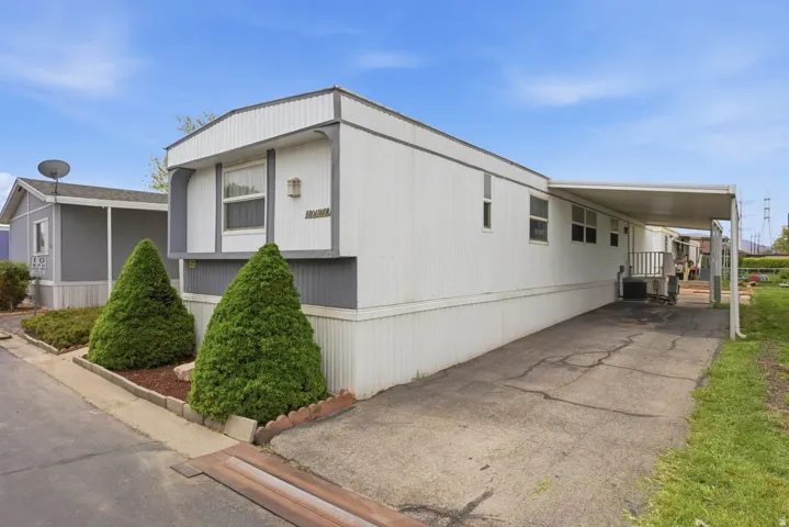 North Side with covered carport and uncovered parking space