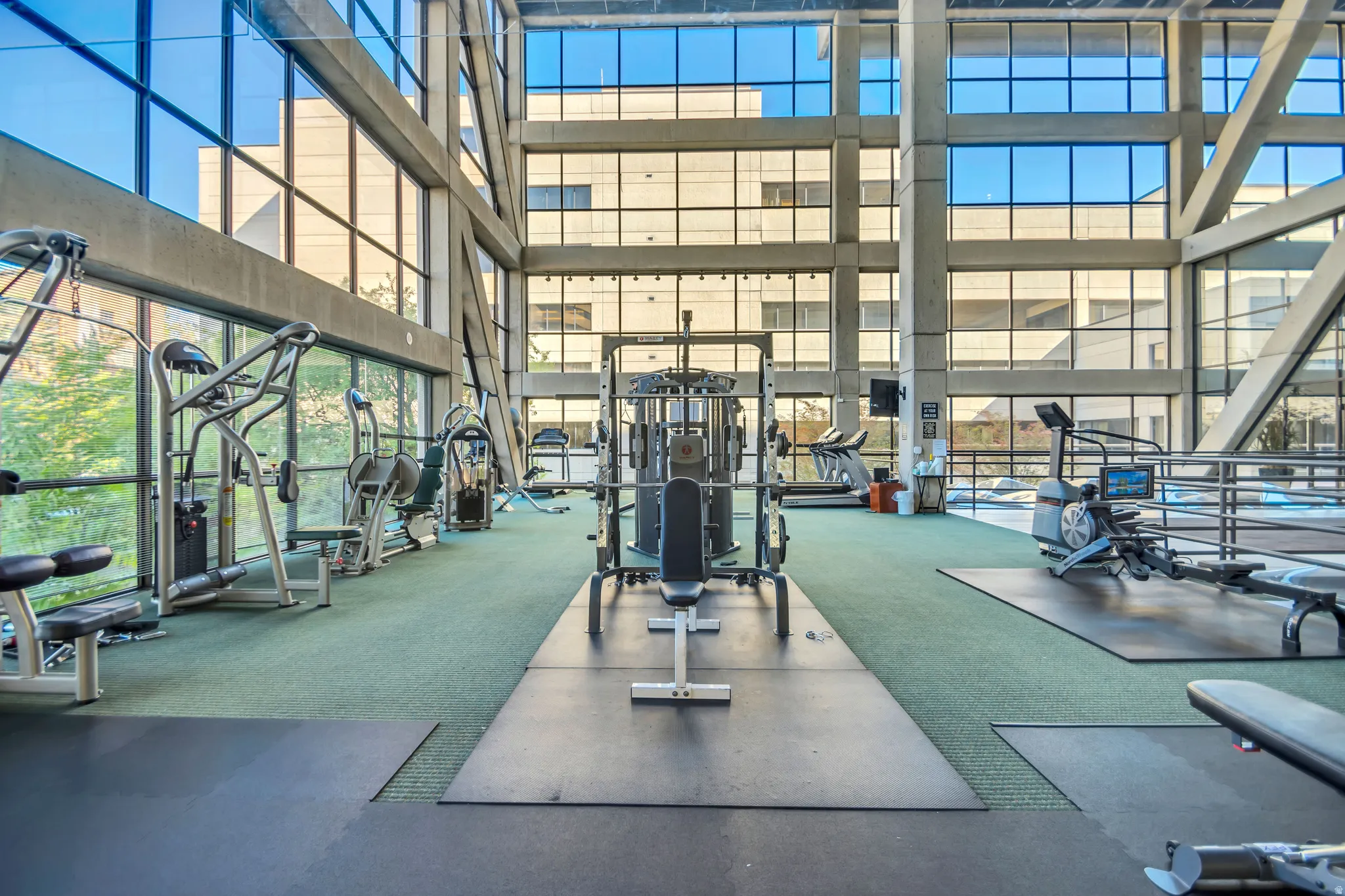 Workout area featuring a high ceiling and floor to ceiling windows