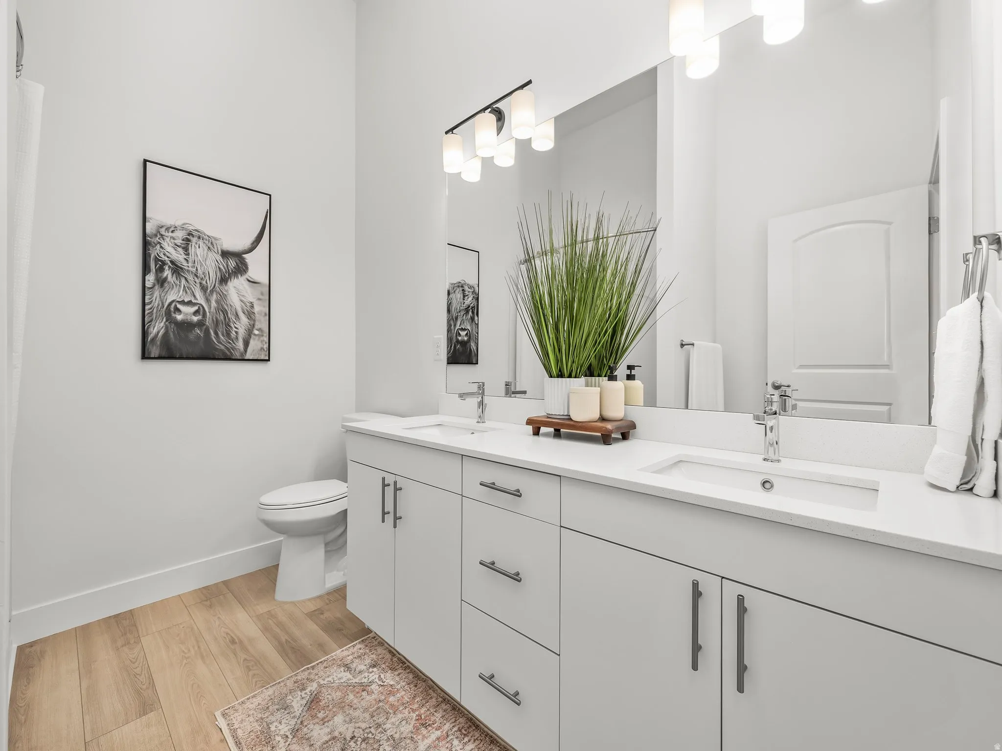 Primary bedroom en' suite with double vanity and walk in shower