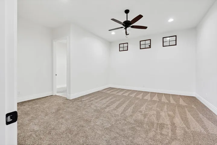 Spare room with recessed lighting, light carpet, and ceiling fan