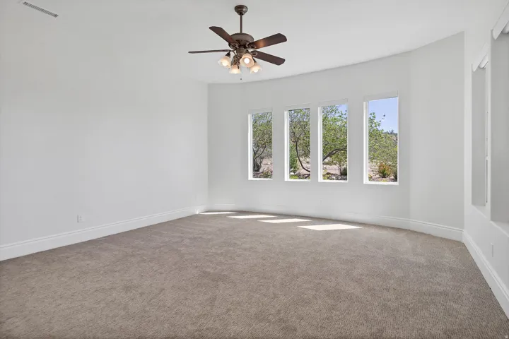 Unfurnished room with carpet and ceiling fan