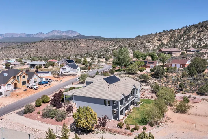 Aerial perspective of suburban area featuring a mountain backdrop
