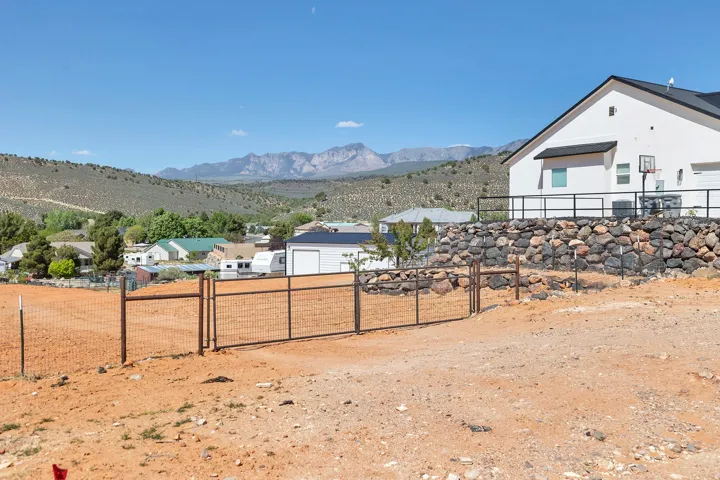 View of yard featuring a gate, a mountain view, and a residential view