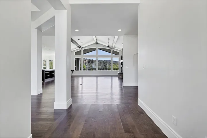 Corridor featuring beamed ceiling, dark wood-style flooring, and recessed lighting