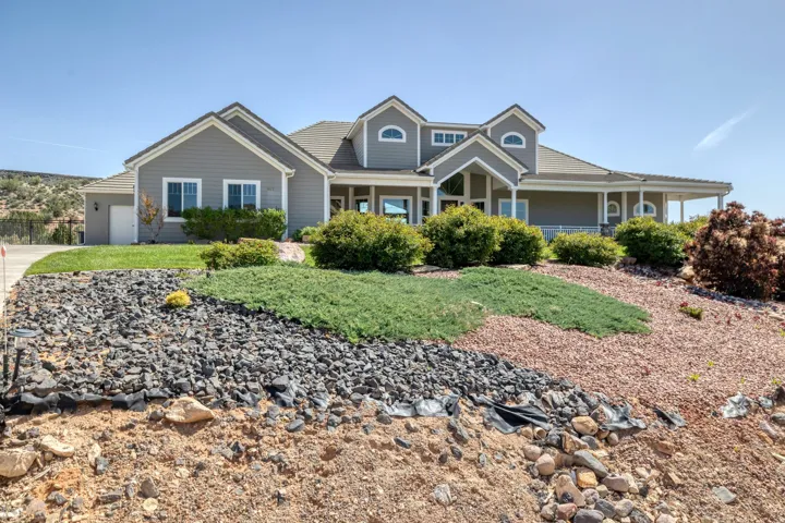 View of front of home with a porch and an attached garage