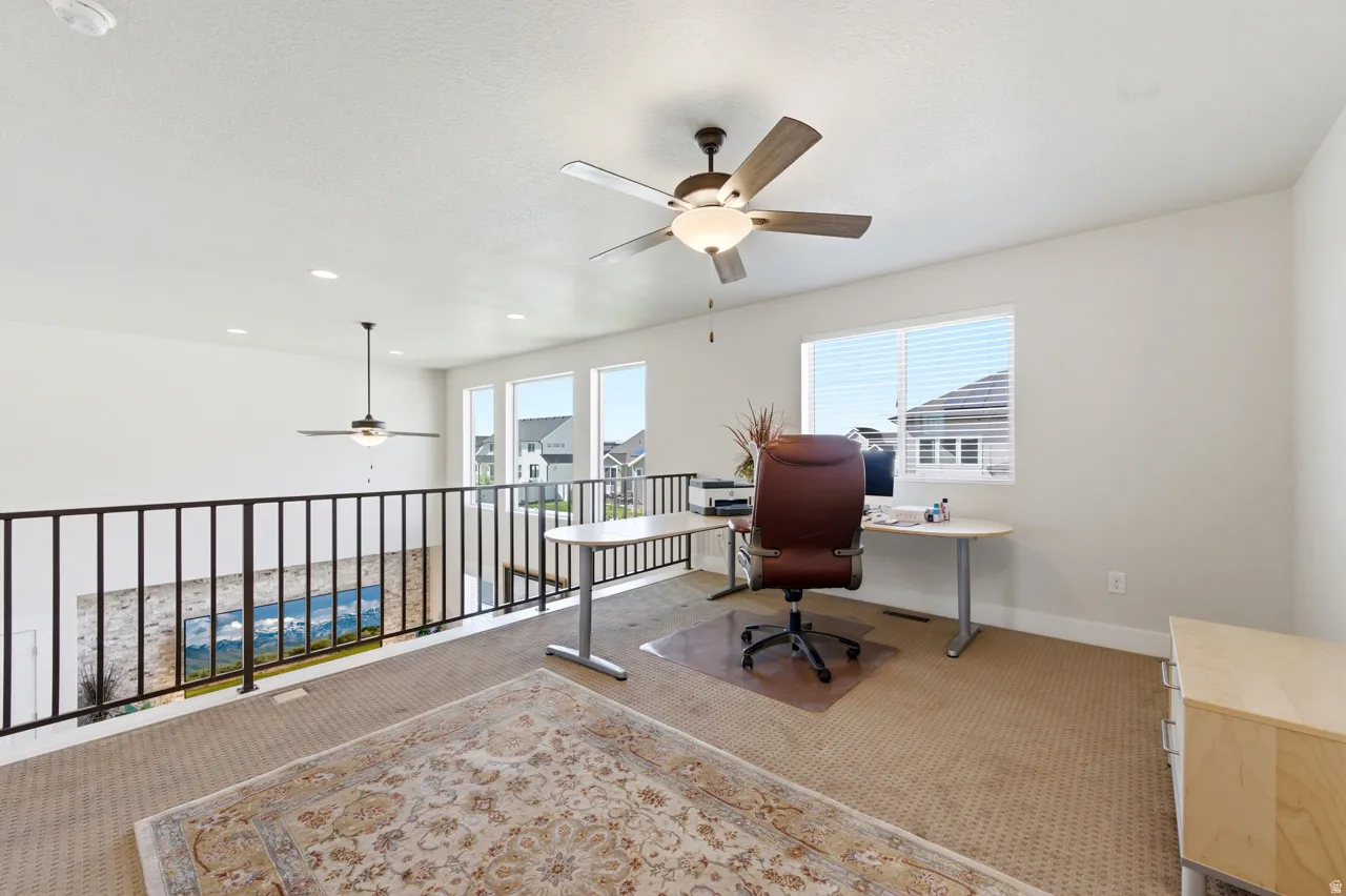 Home office featuring ceiling fan, carpet flooring, and recessed lighting