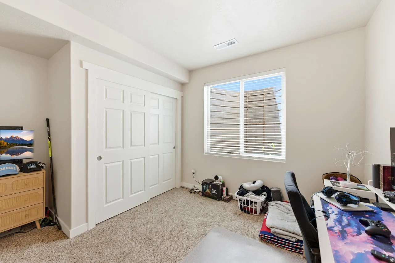 Office space with light colored carpet and baseboards