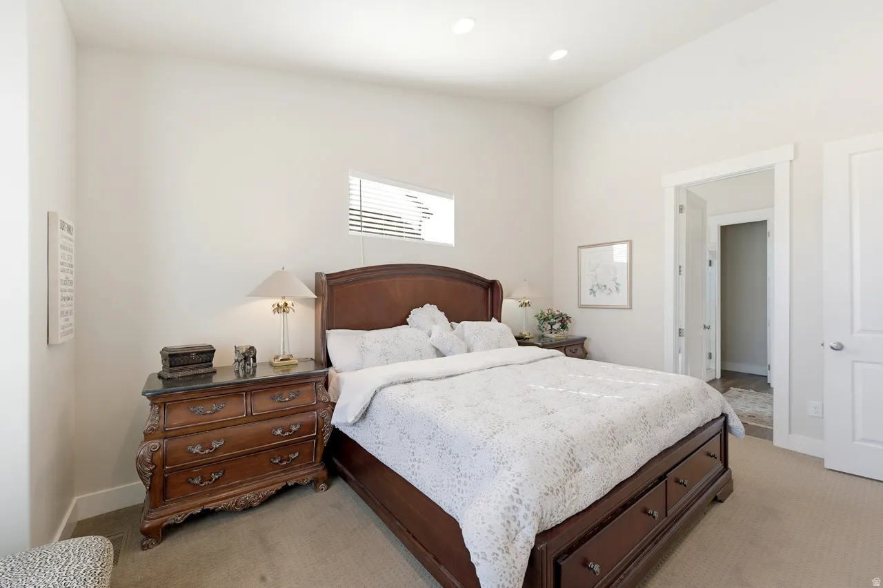 Bedroom featuring light carpet and recessed lighting