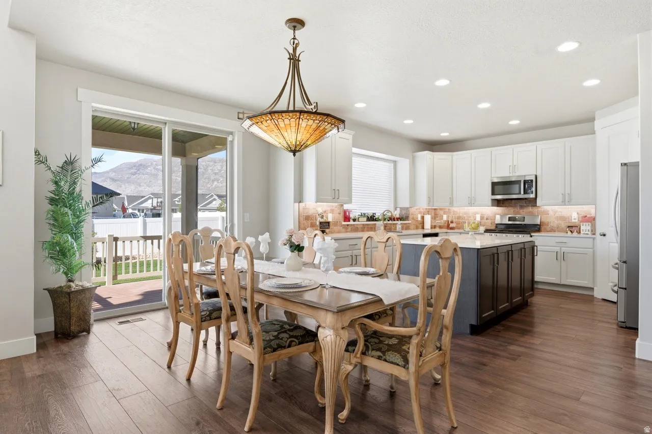 Dining area with healthy amount of natural light, recessed lighting, dark wood finished floors, and a mountain view
