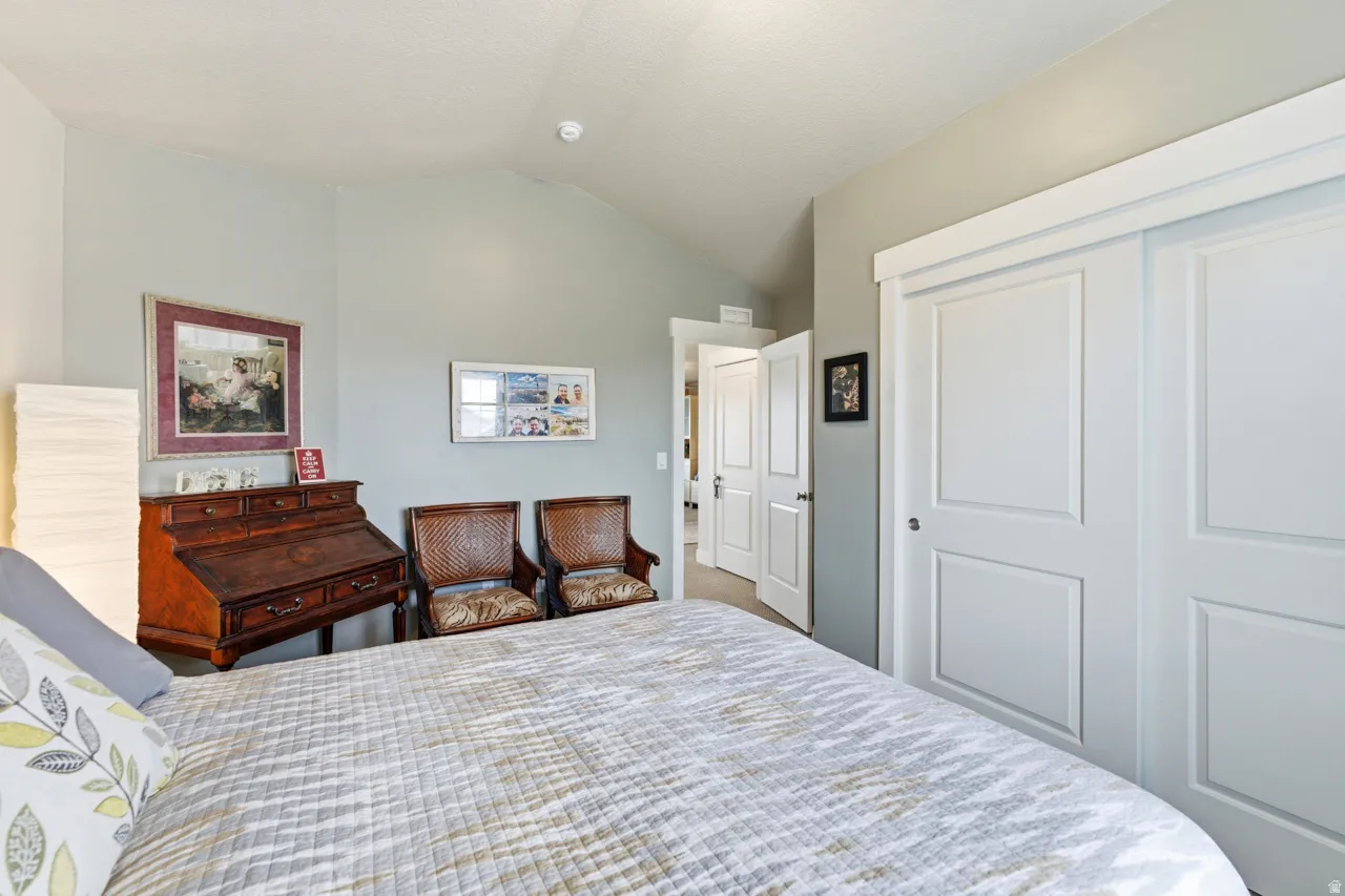 Bedroom with vaulted ceiling and a closet