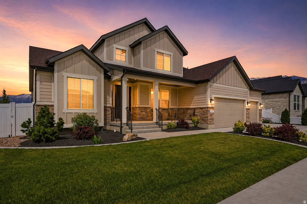 AI enhanced twilight. Craftsman house featuring board and batten siding, covered porch, a garage, and stone siding