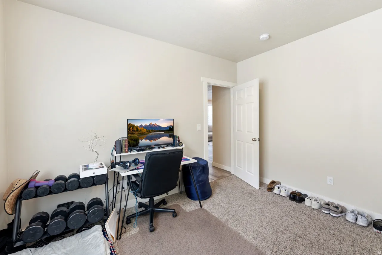 Office with light carpet and baseboards