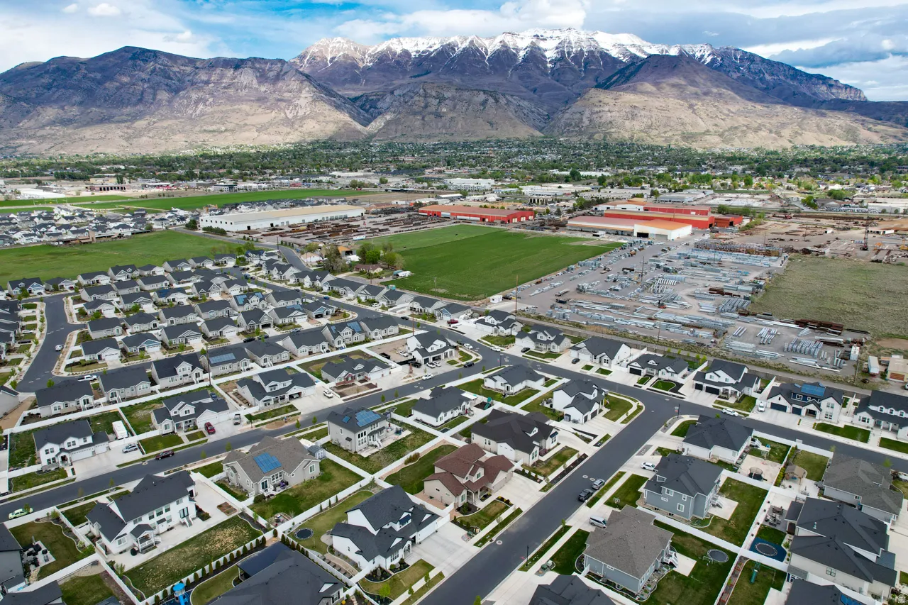 Aerial perspective of suburban area featuring a mountainous background