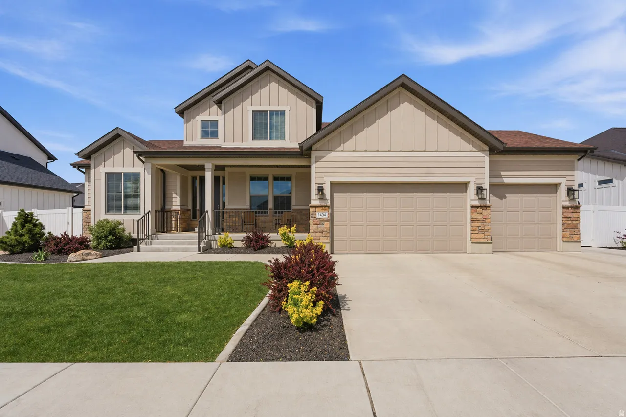 AI enhanced lawn. Craftsman-style house featuring board and batten siding, a porch, an attached garage, and driveway