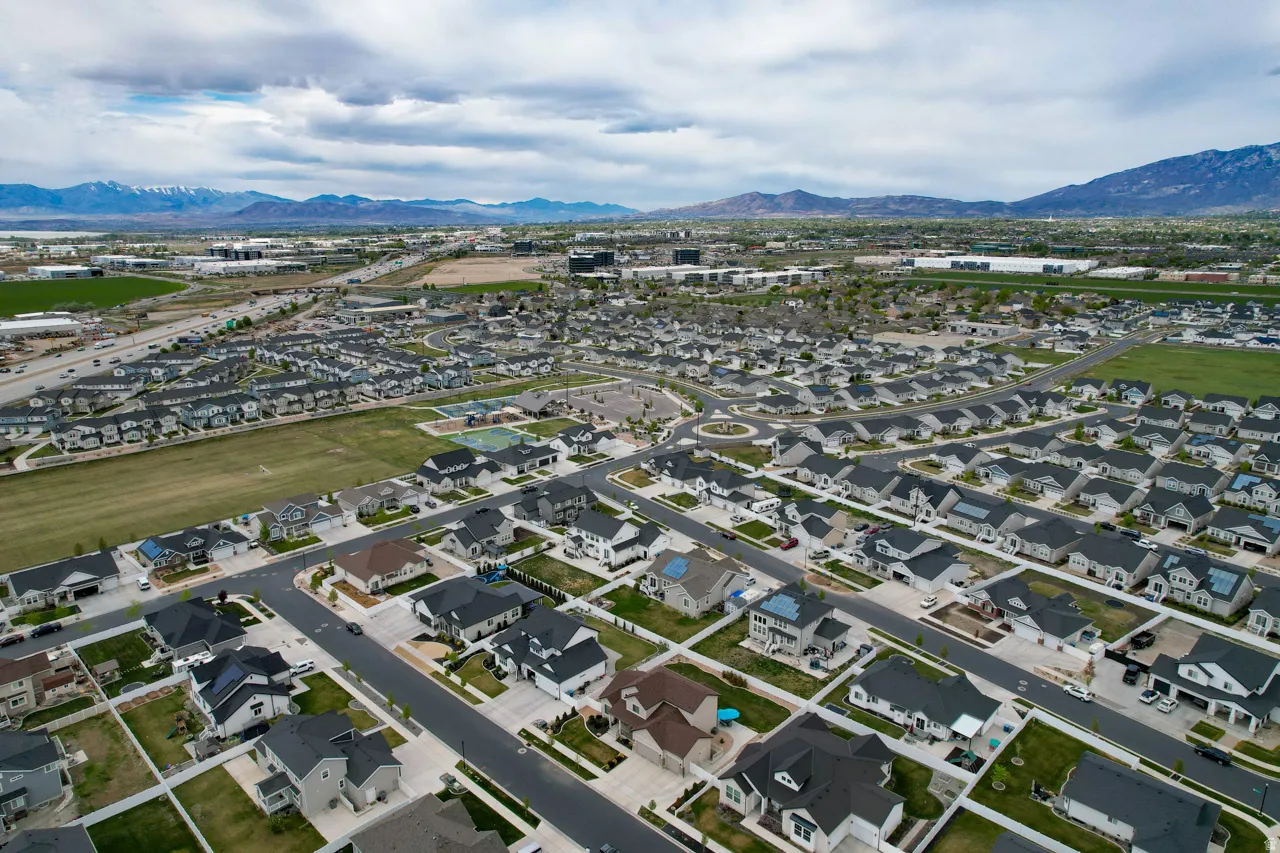 Aerial perspective of suburban area with a mountainous background