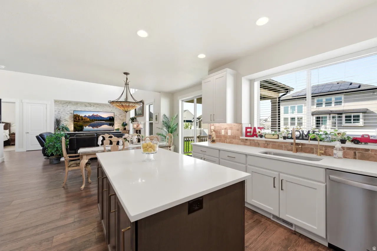 Kitchen with a center island, dishwasher, open floor plan, dark wood-style floors, and dual tone cabinetry