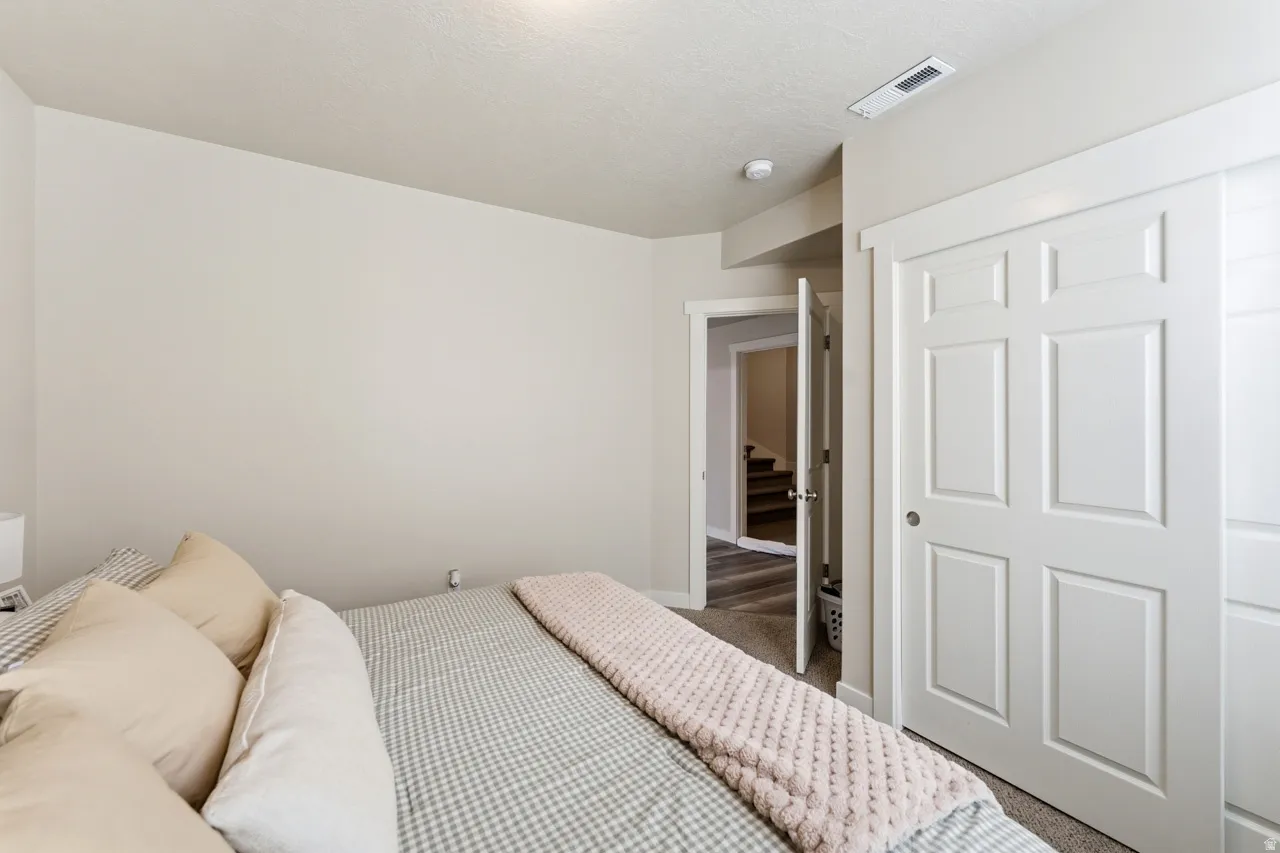 Carpeted bedroom with a closet