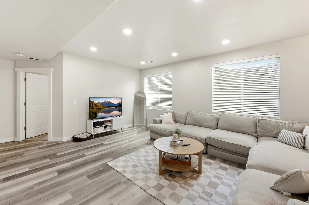Living room featuring light wood-style flooring and recessed lighting