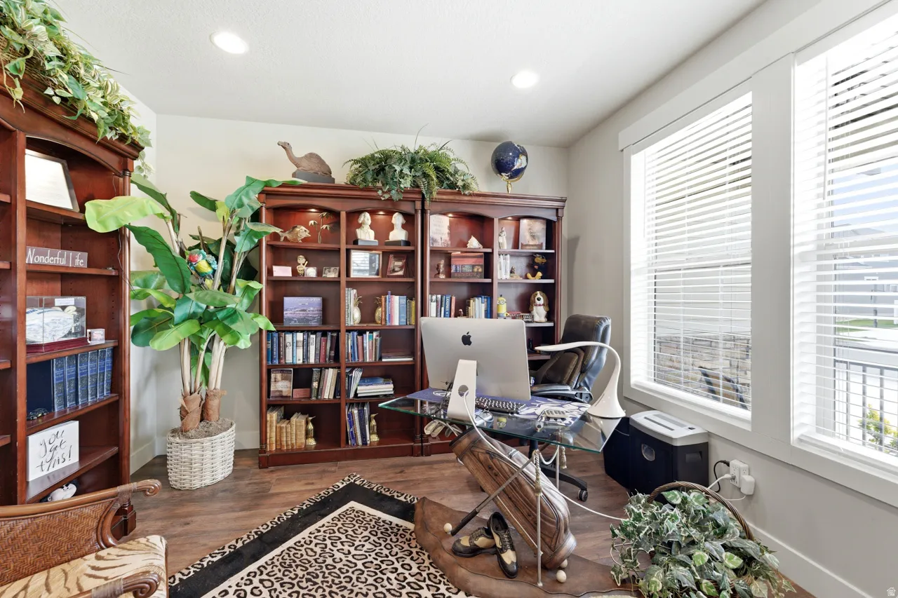 Office with dark wood-type flooring, healthy amount of natural light, and recessed lighting