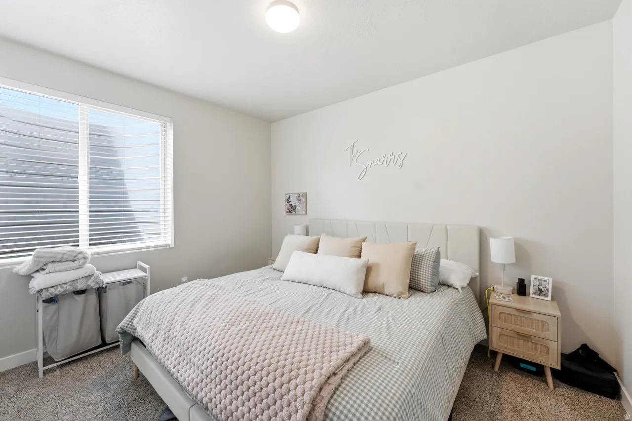 Carpeted bedroom featuring baseboards