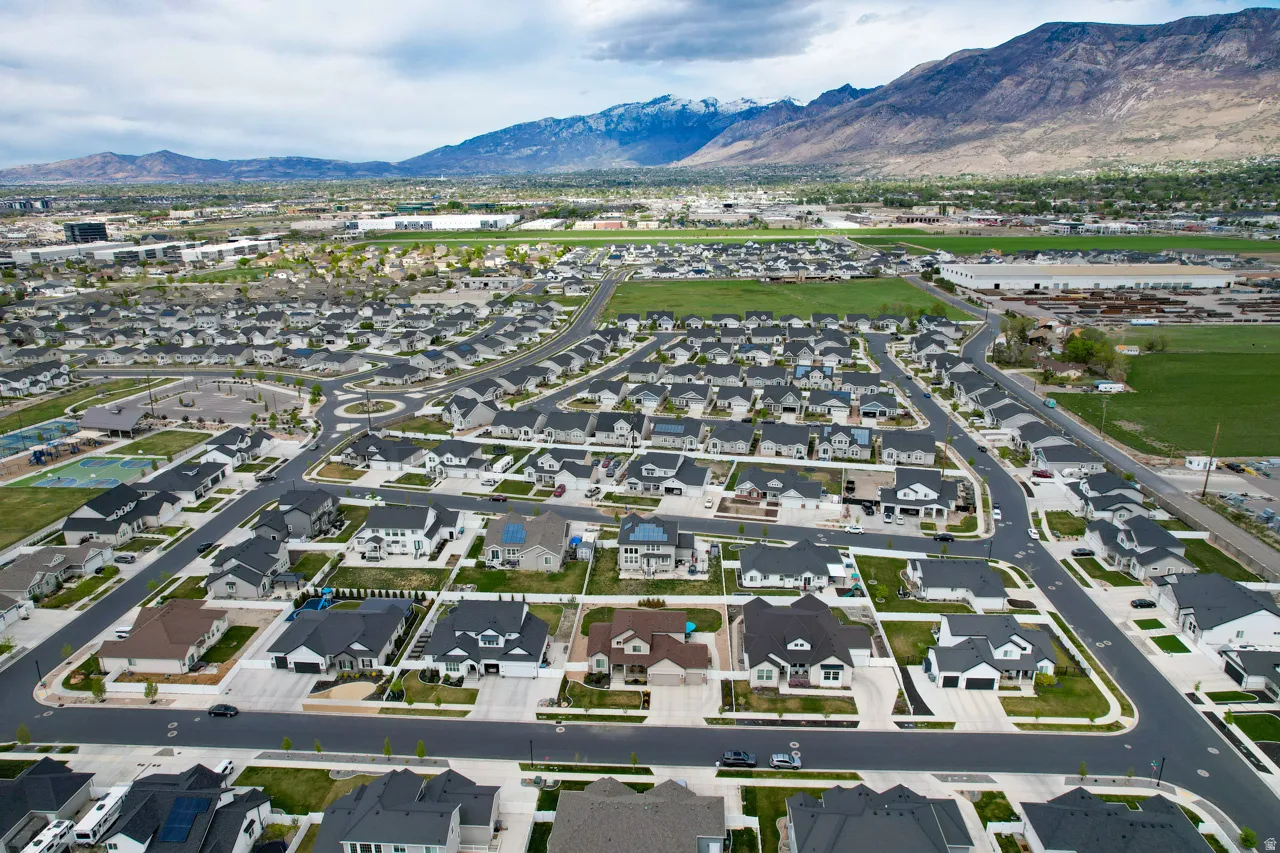 Aerial overview of property's location featuring nearby suburban area and mountains