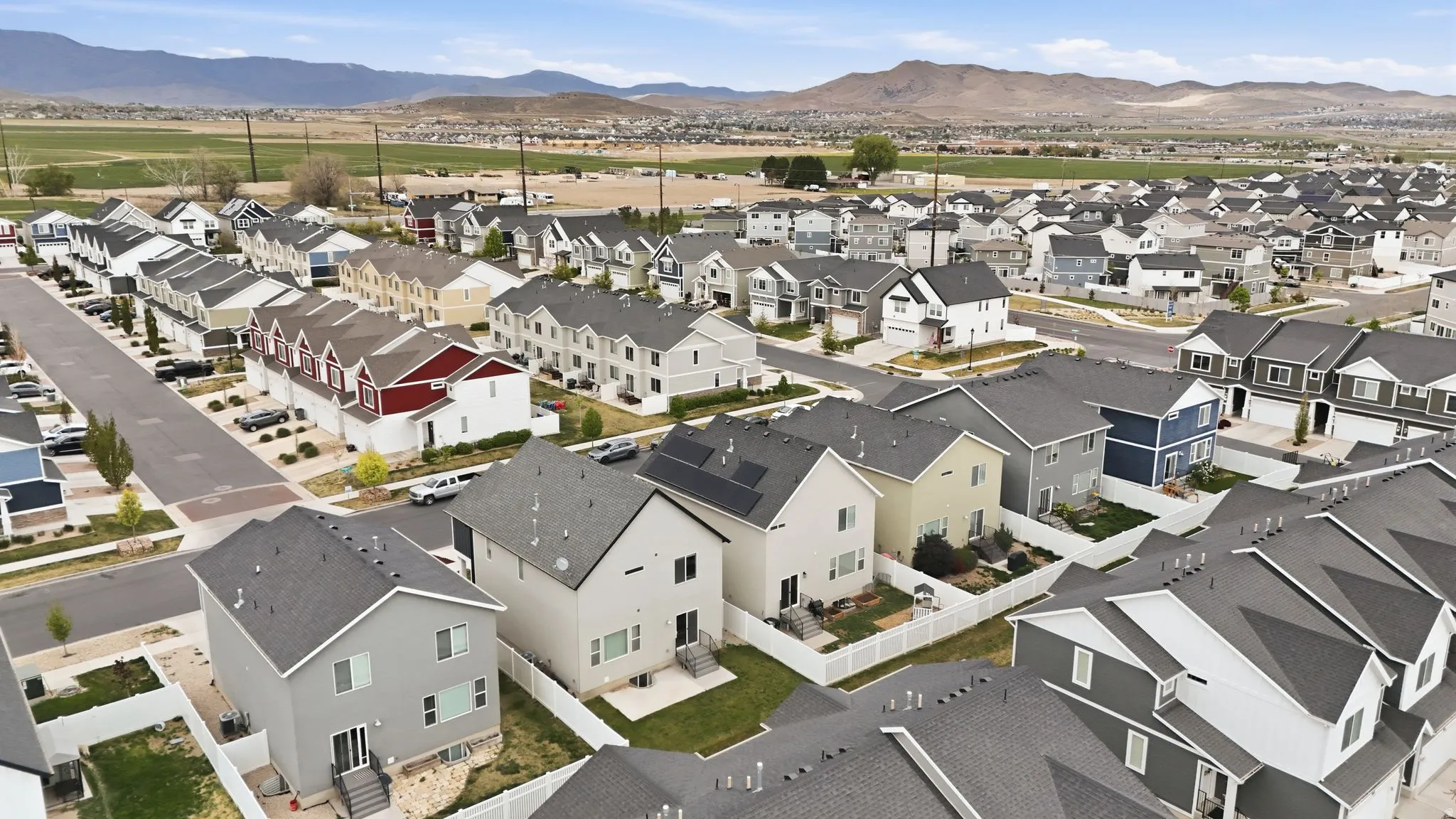 Aerial perspective of suburban area with a mountainous background