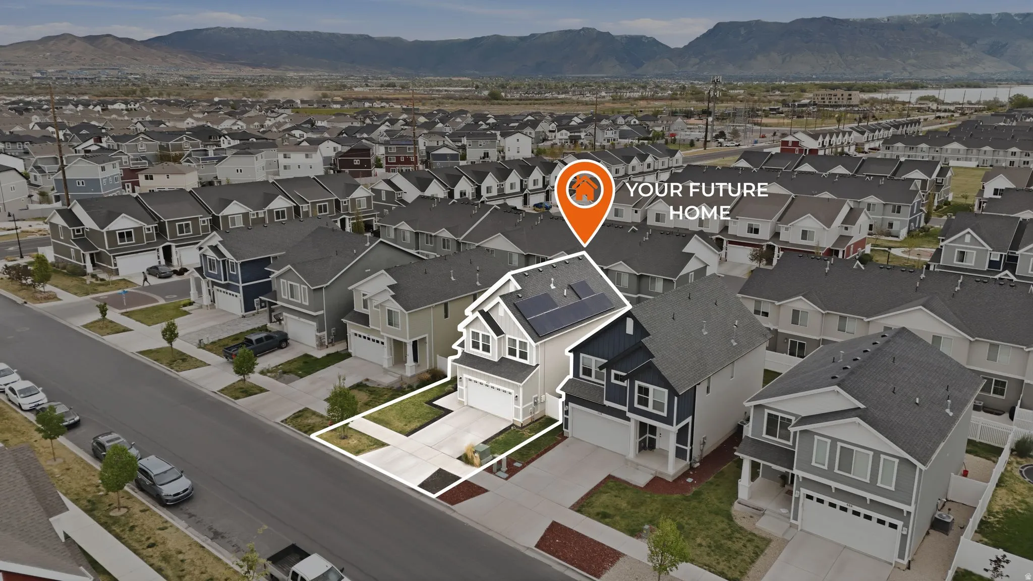 Aerial perspective of suburban area featuring a mountainous background