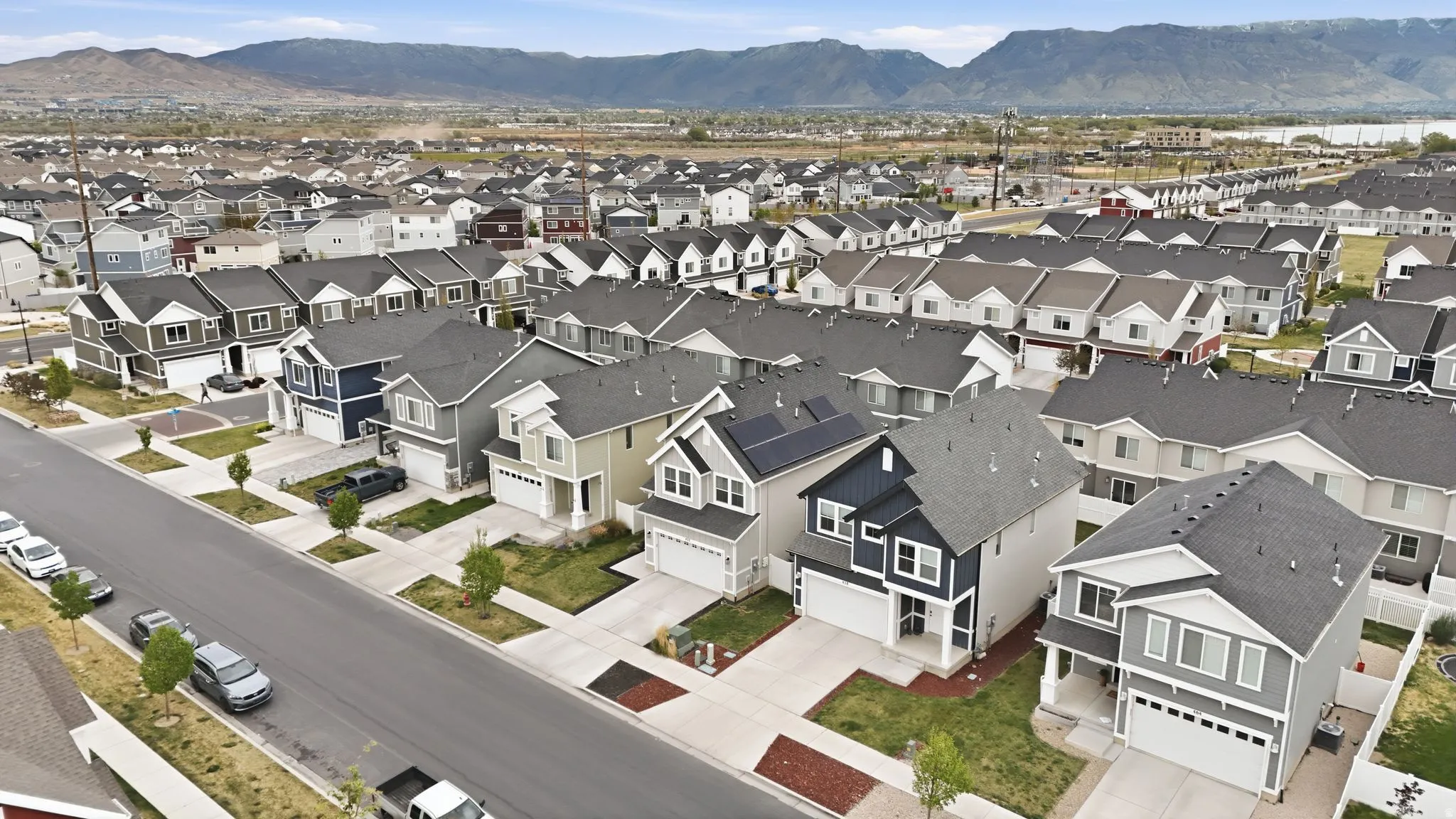 Aerial perspective of suburban area with a mountainous background