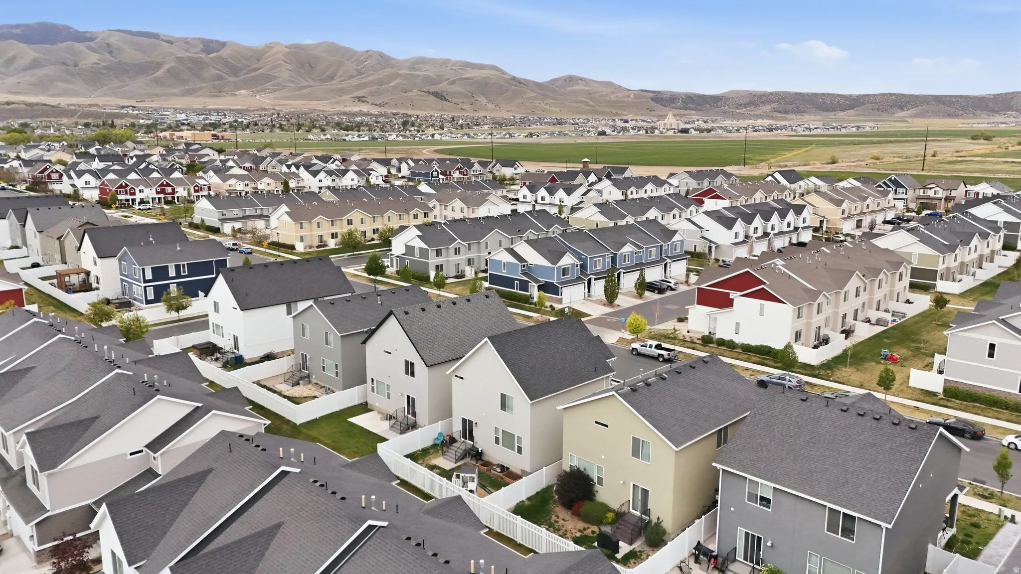 Aerial view of residential area featuring a mountainous background