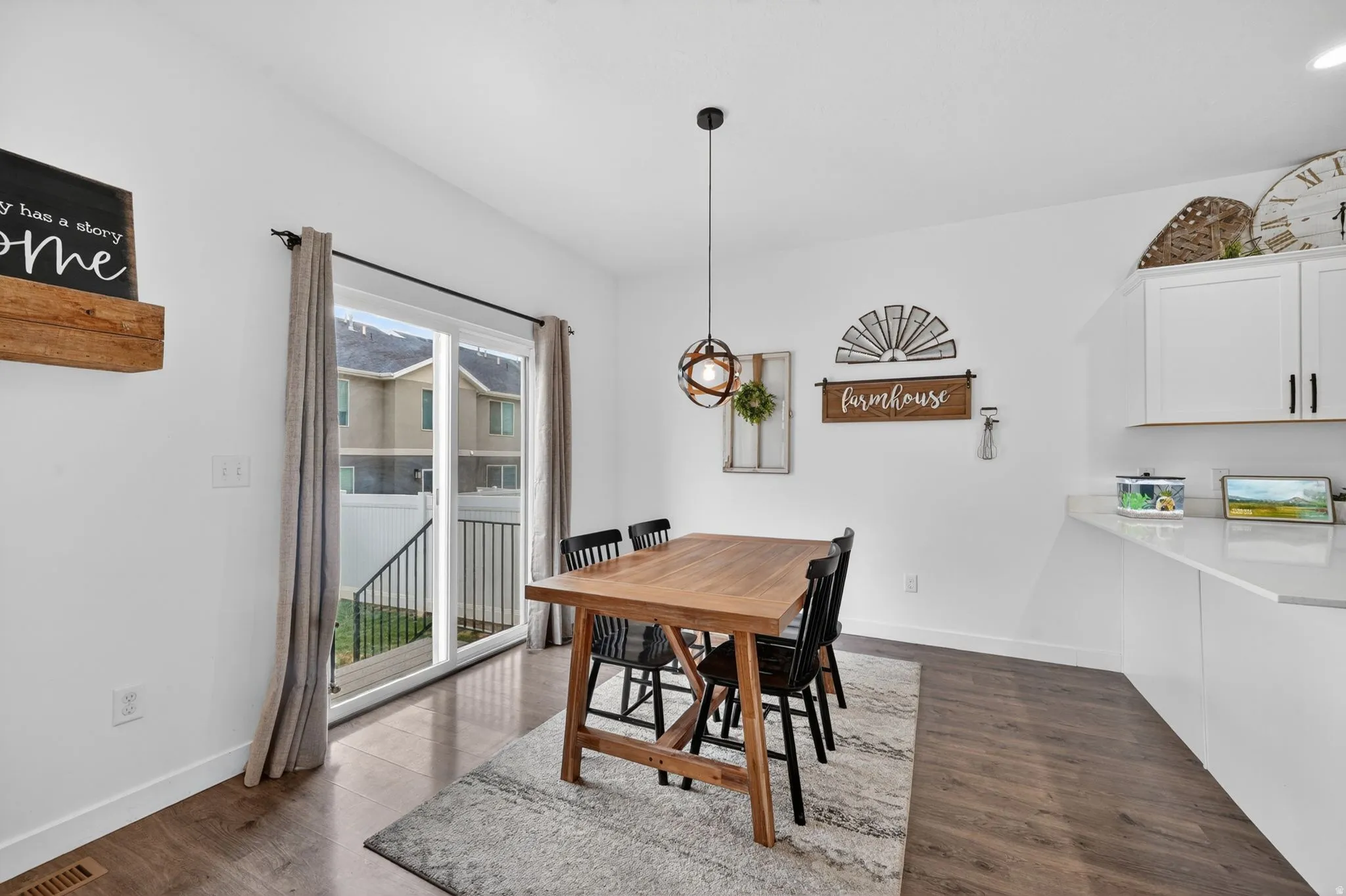 Dining room with dark wood-style floors and baseboards