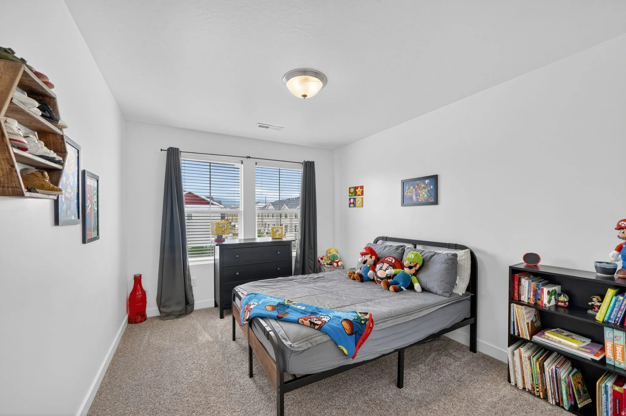 Bedroom with baseboards and light carpet