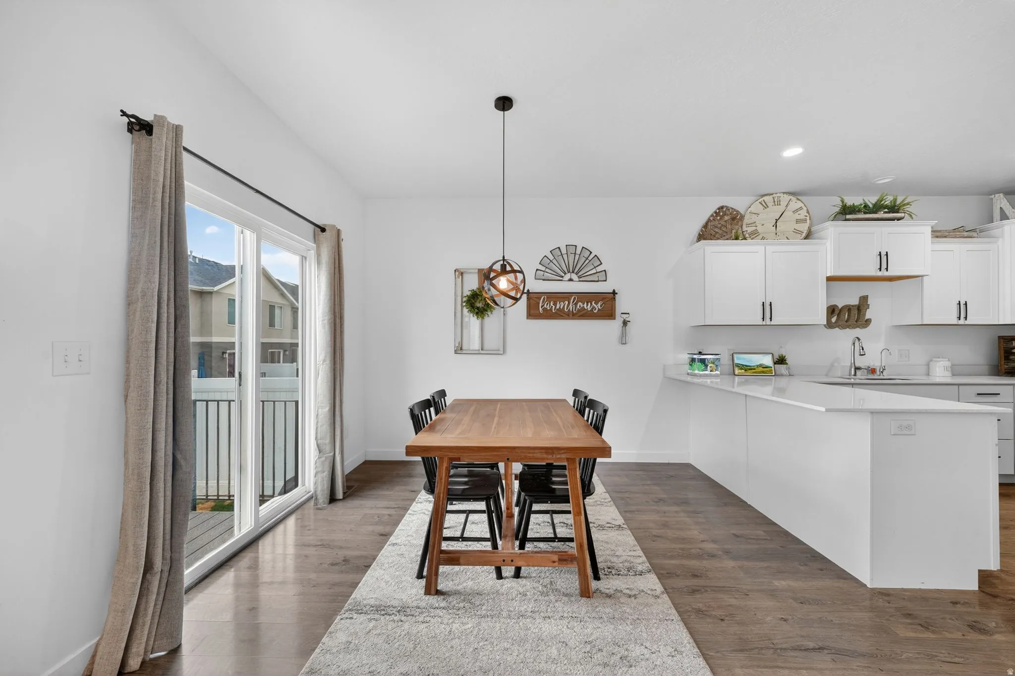 Dining space with dark wood-type flooring and recessed lighting