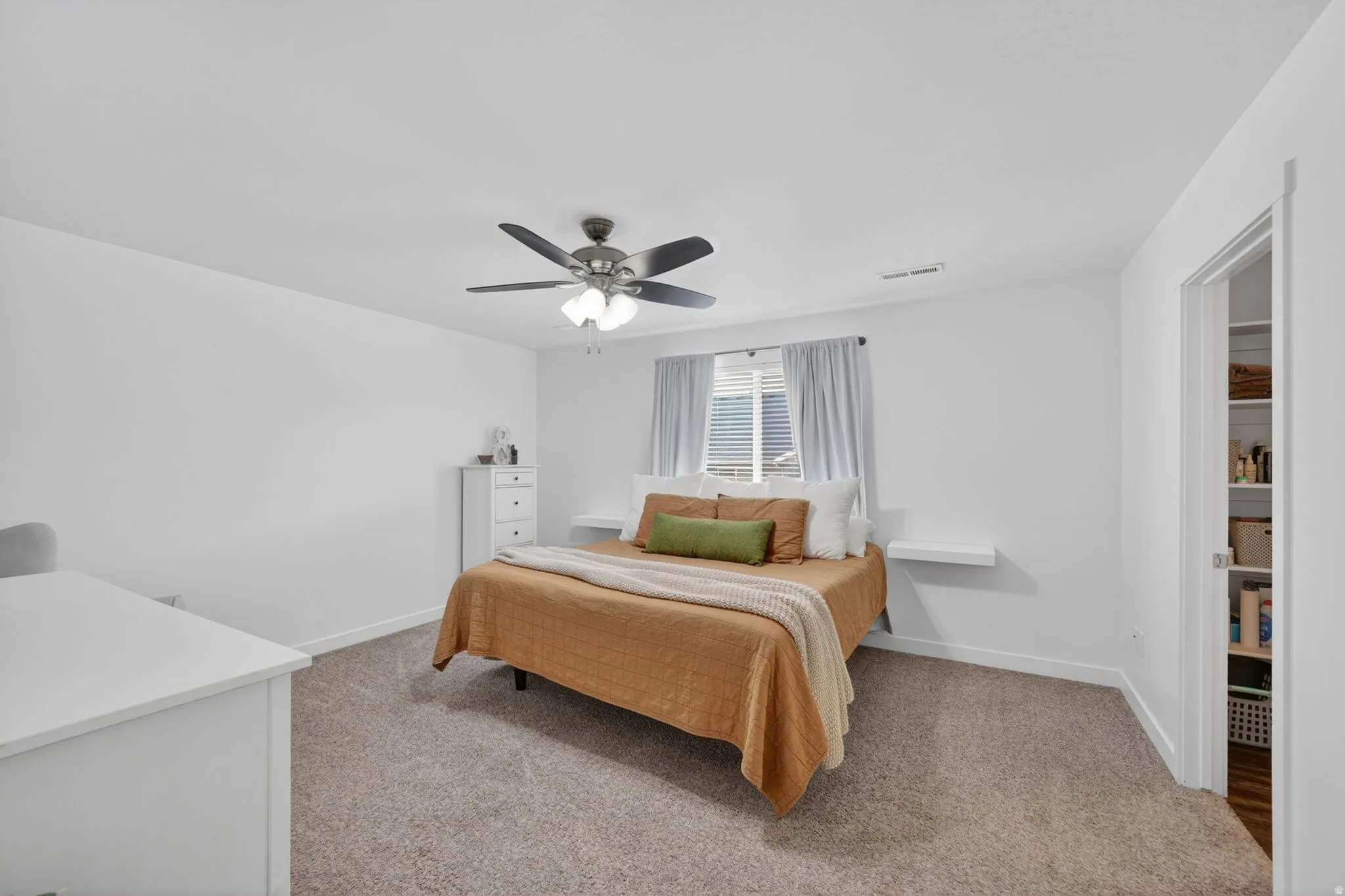Bedroom featuring light carpet and ceiling fan