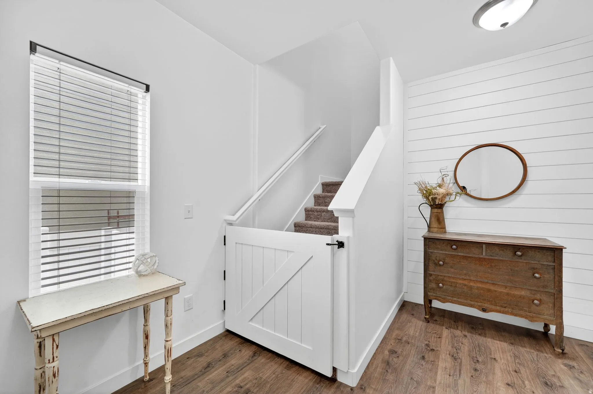 Stairs featuring wood finished floors