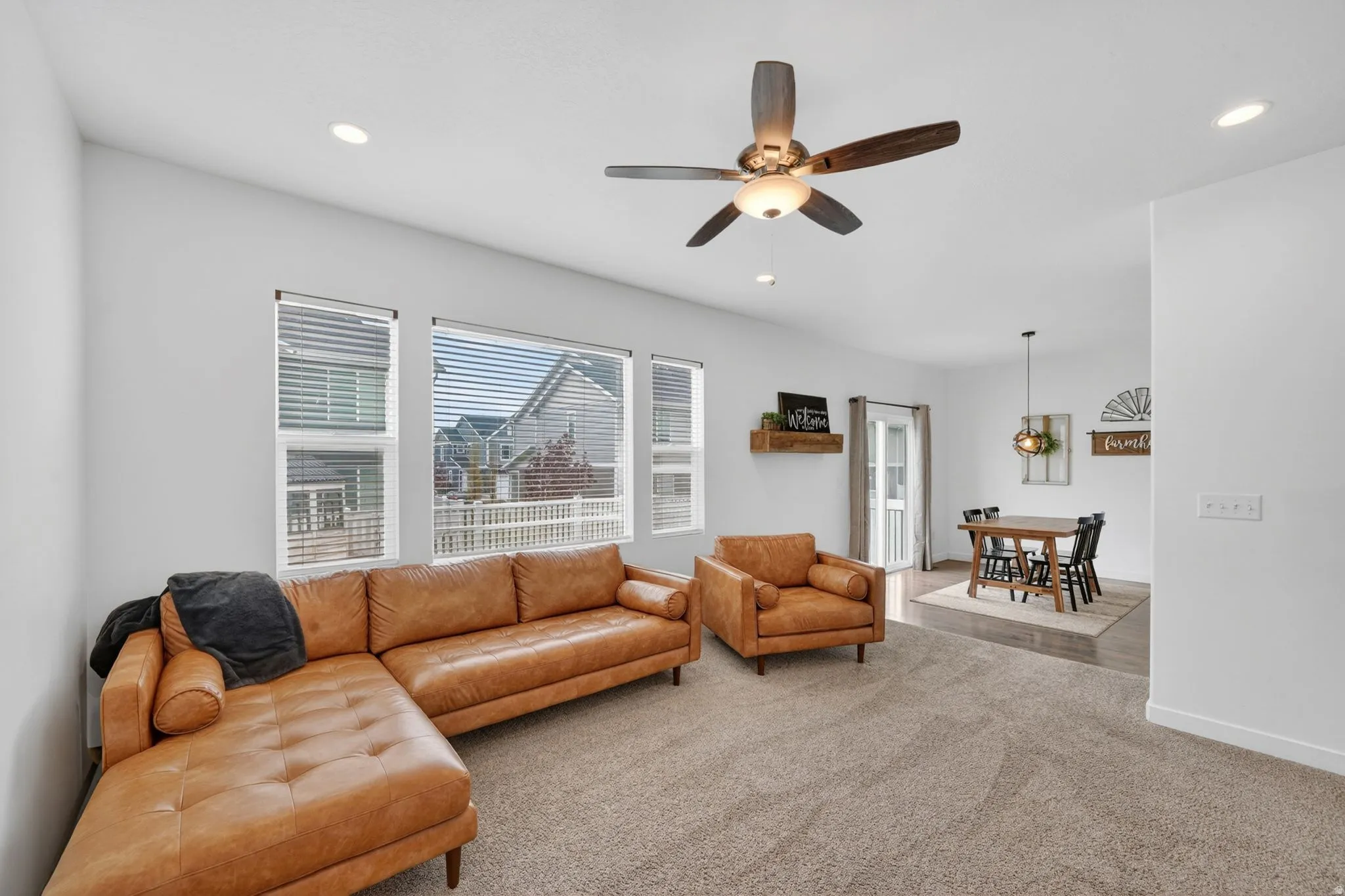 Living room with carpet flooring, recessed lighting, and ceiling fan